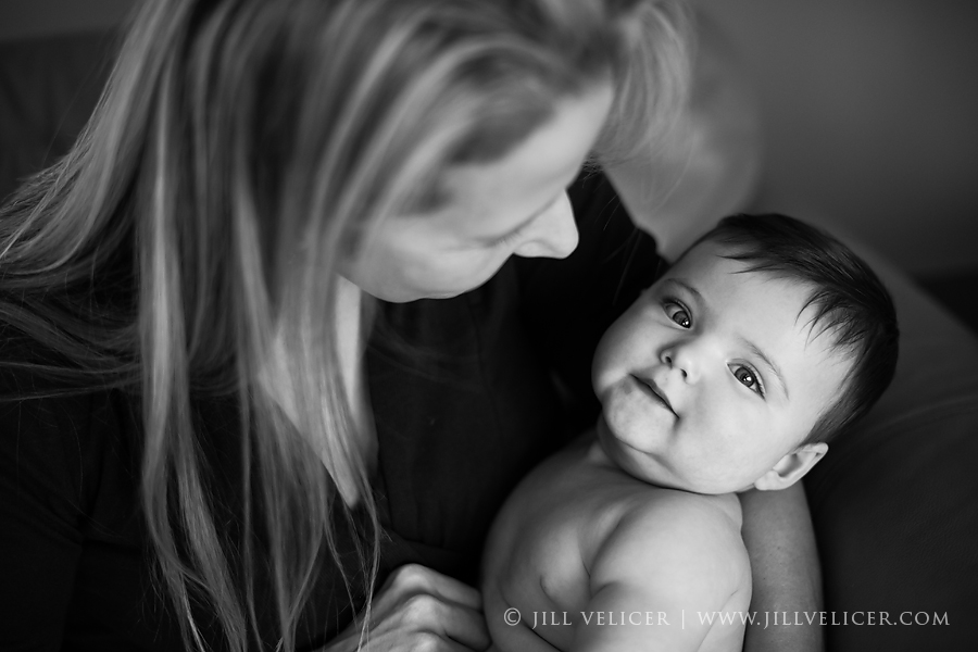 Baby smiling while mother holds baby, baby photographer in Milwaukee